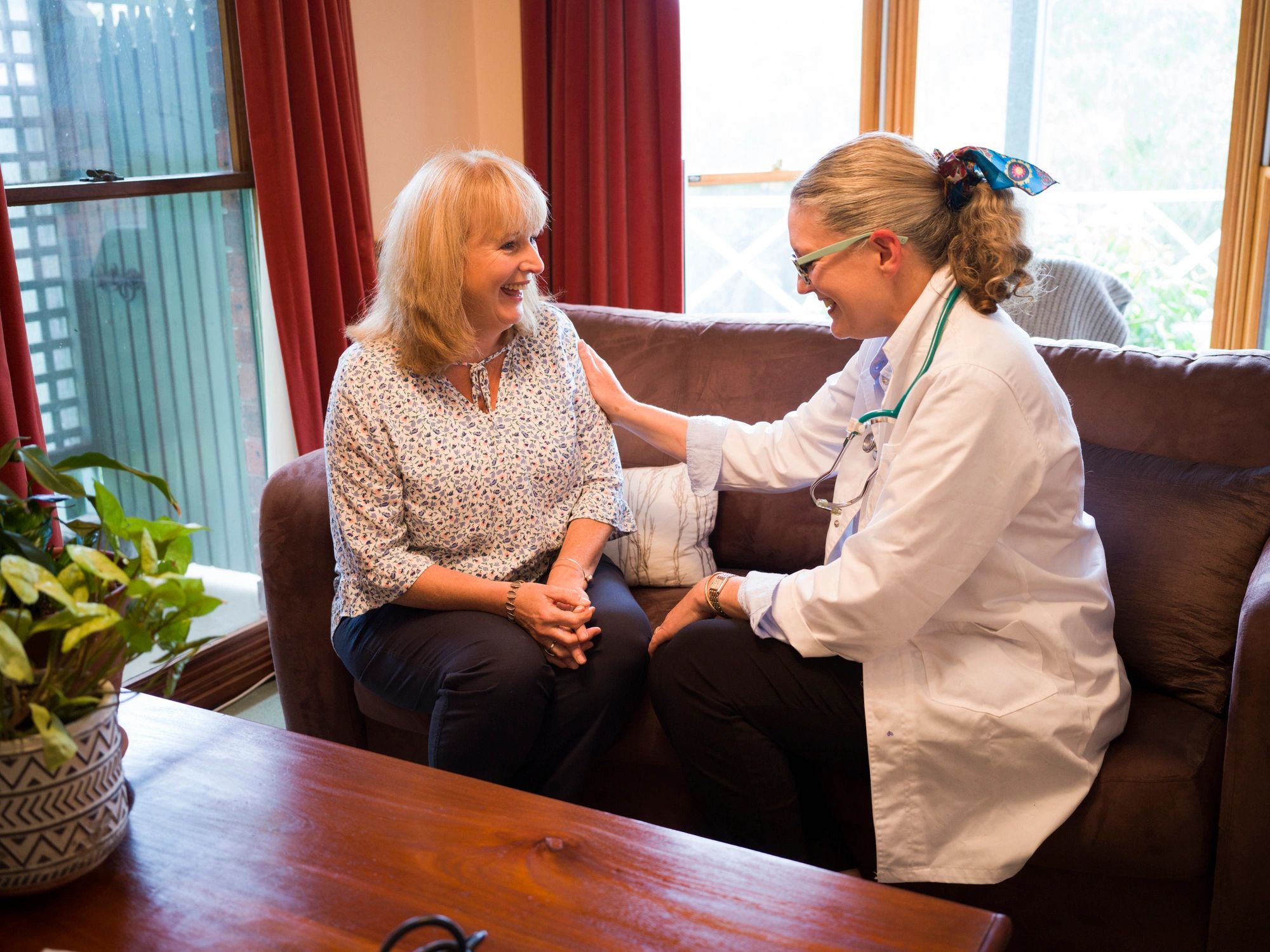 Support worker speaking with a participant at home