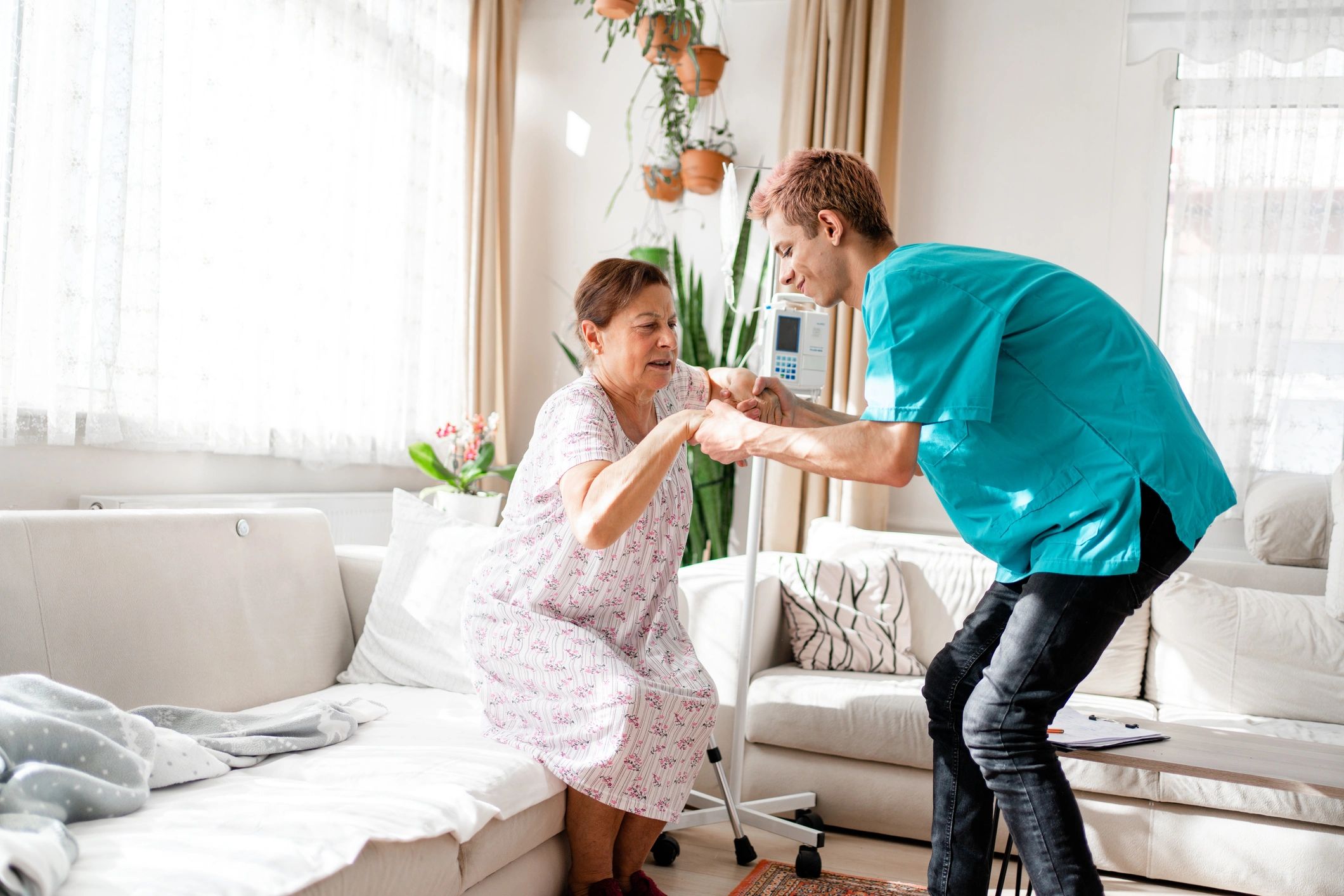 Support worker assisting a participant in a living room