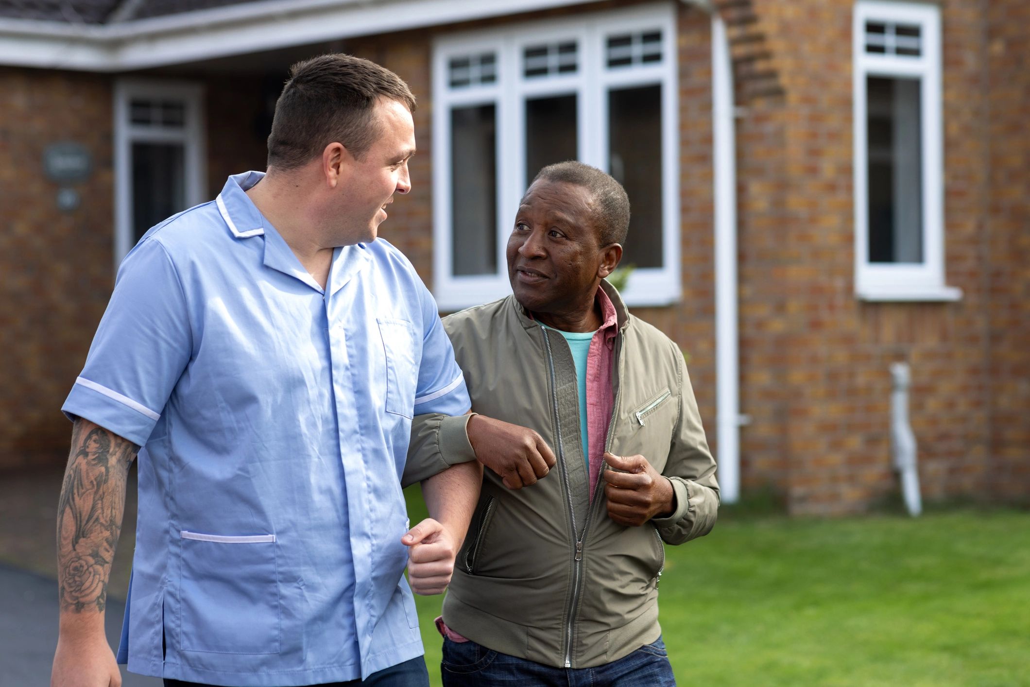 Support worker walking alongside a participant outdoors