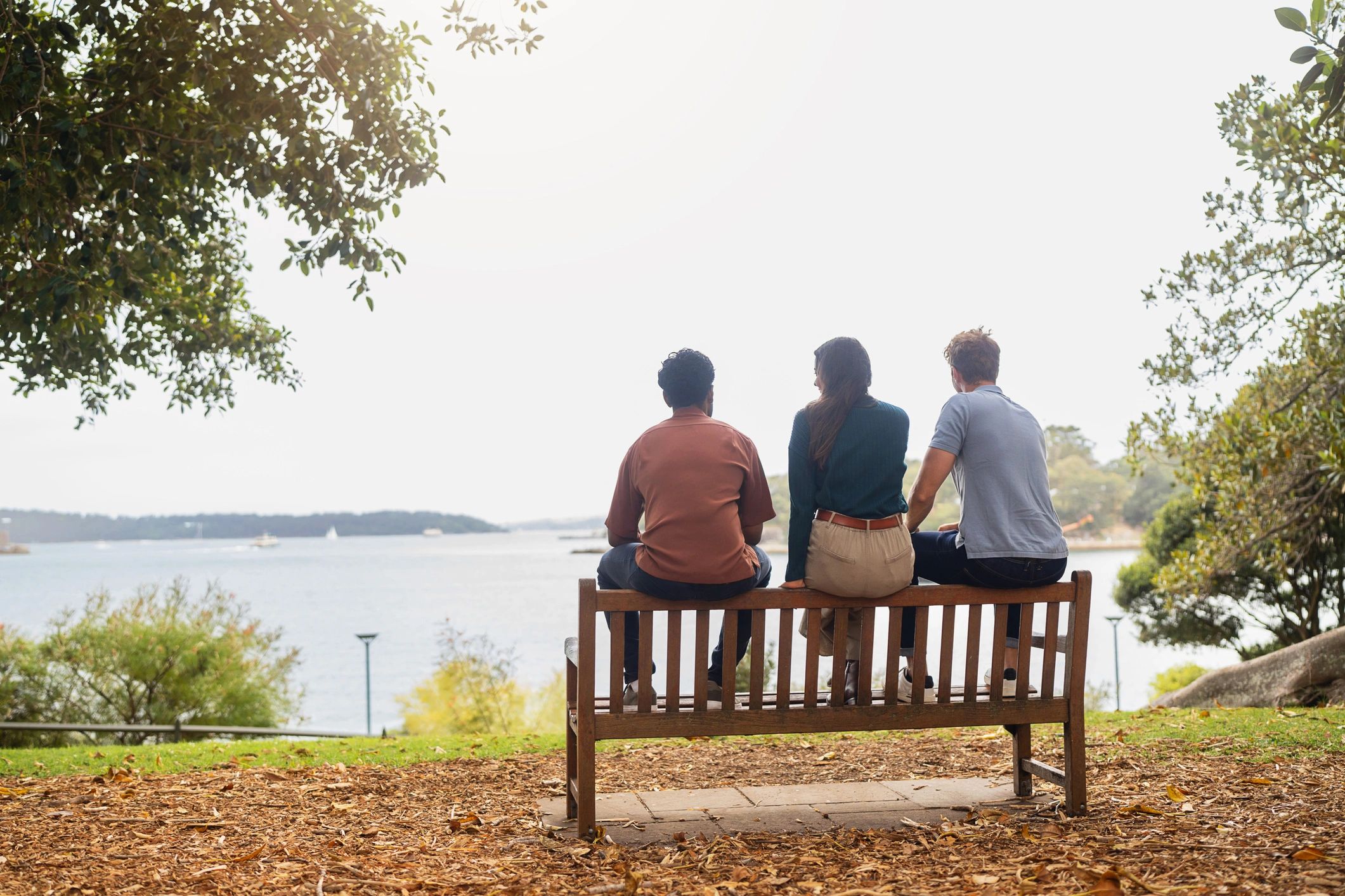 People sitting together on a park bench enjoying companionship outdoors