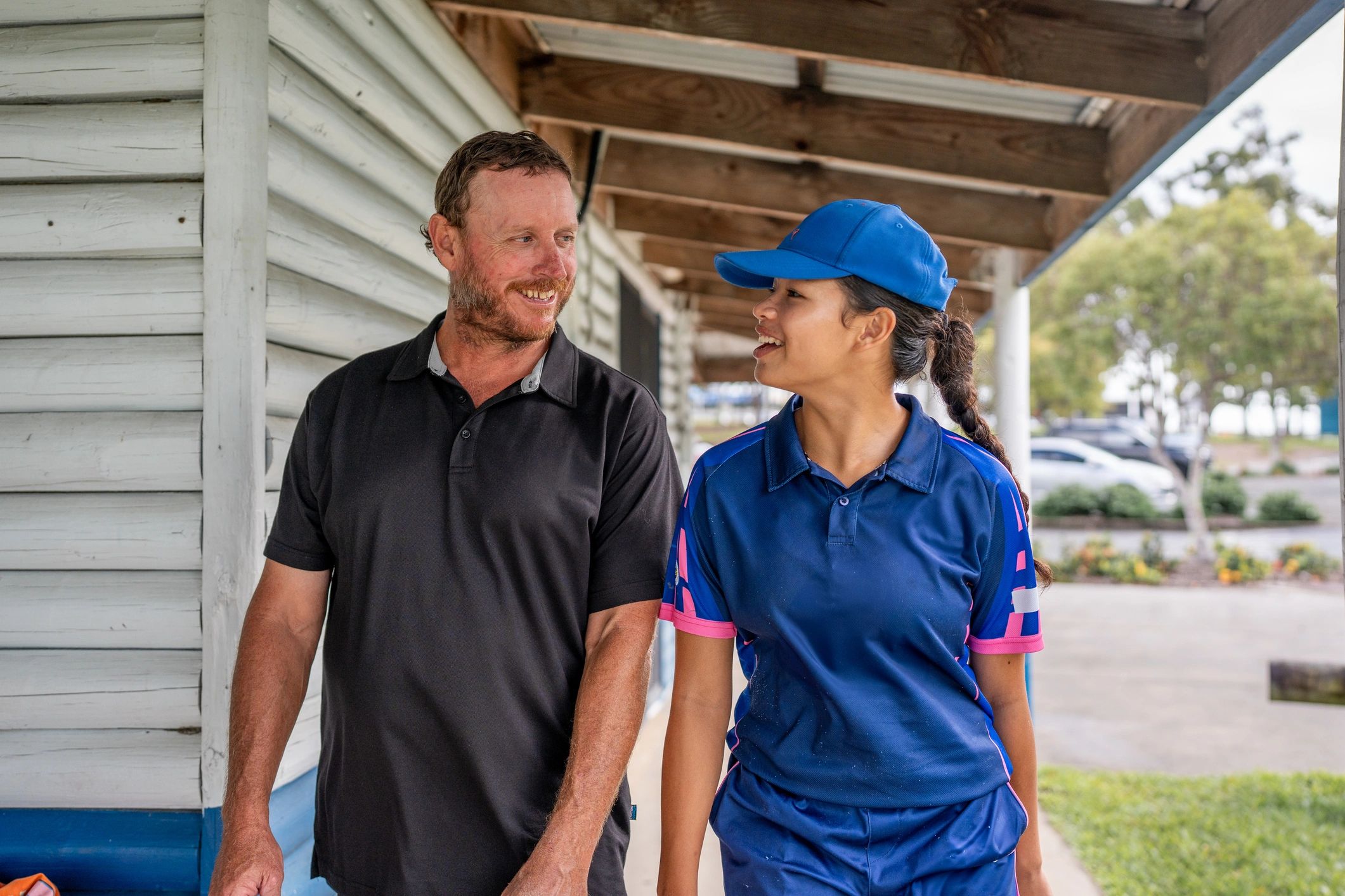 Participant and supporter walking together outdoors