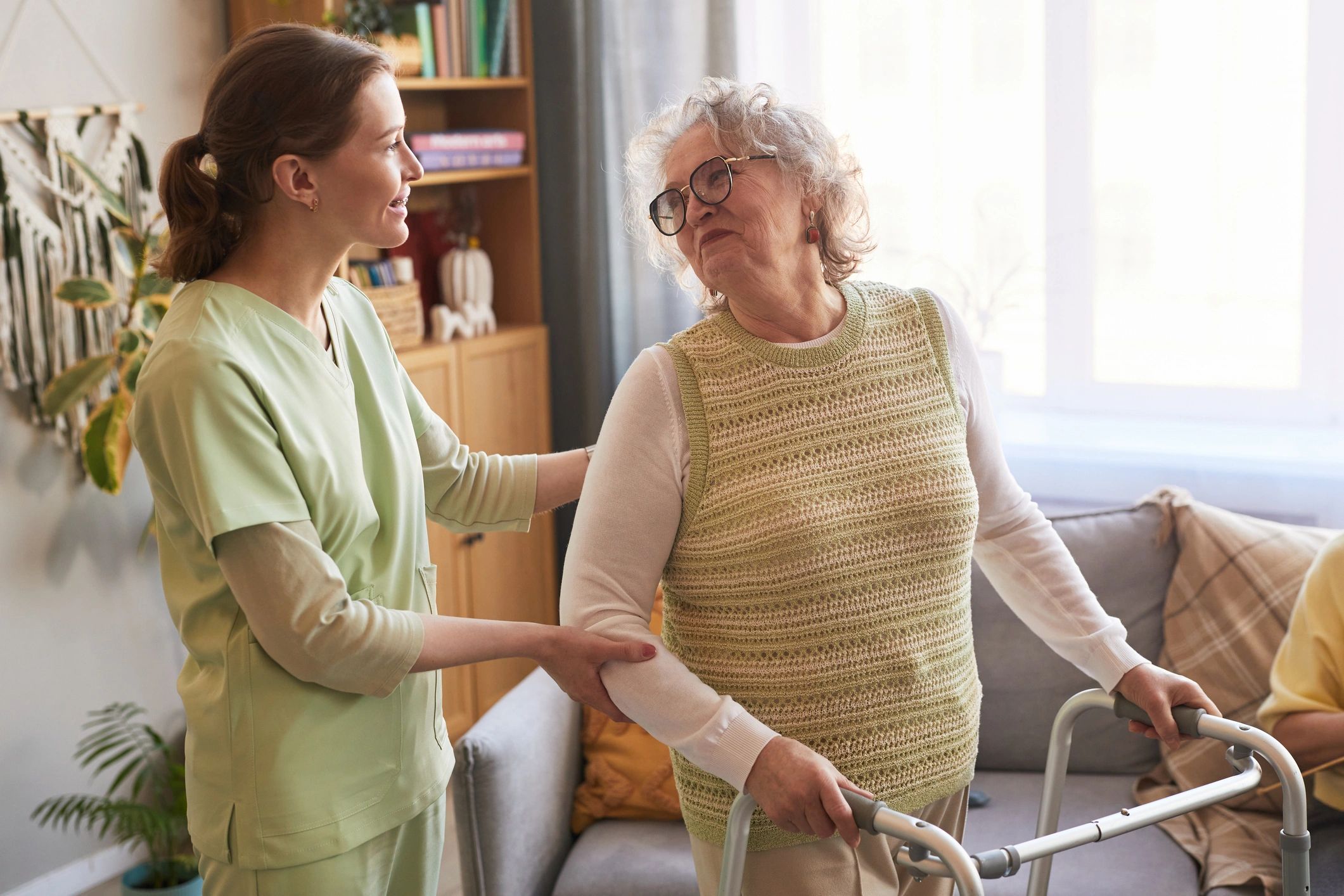Caregiver supporting a participant with mobility practice